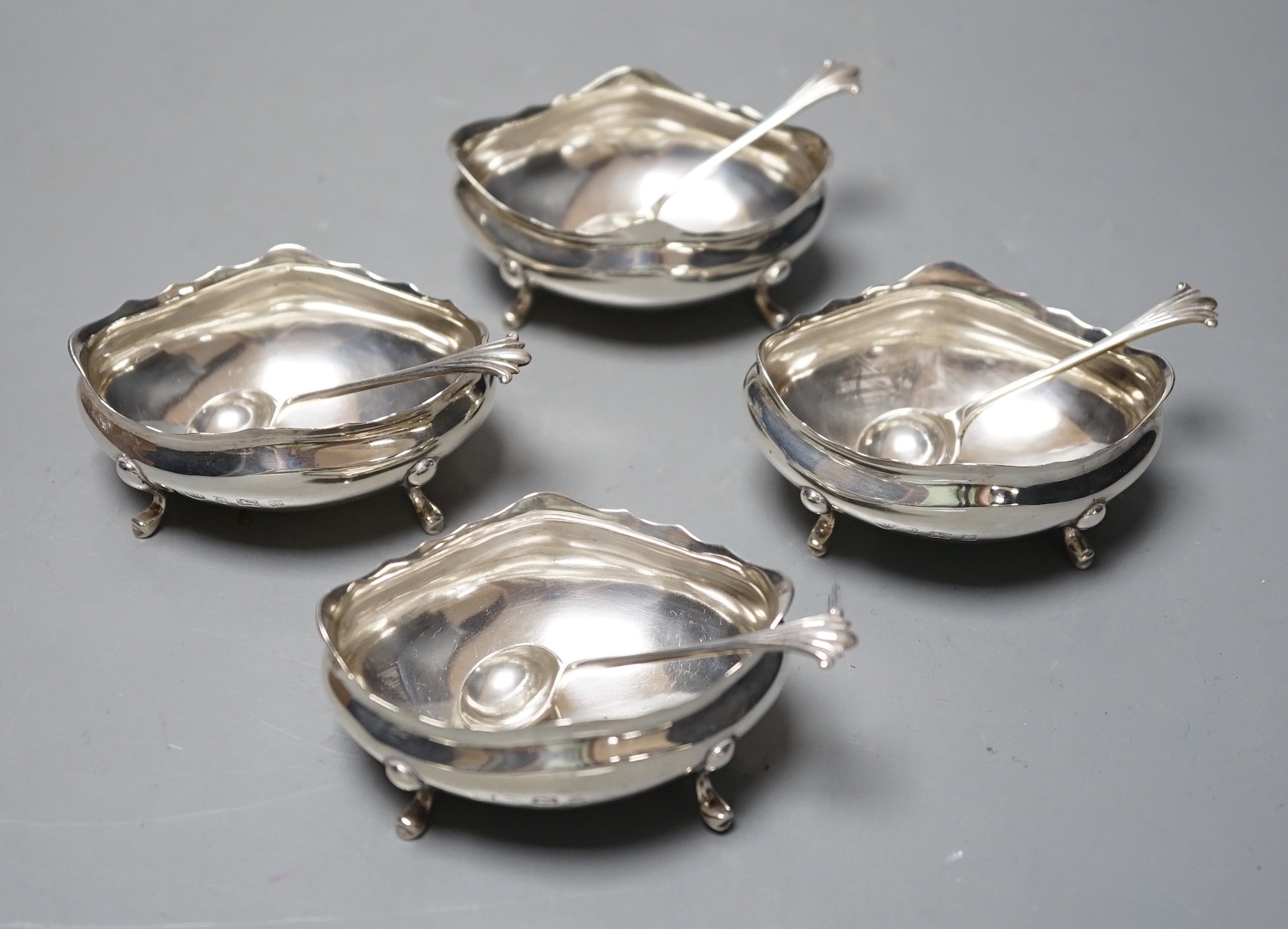 A set of four late Victorian silver oval salts and four matching spoons, Thomas Hayes, Birmingham, 1900, length 59mm.